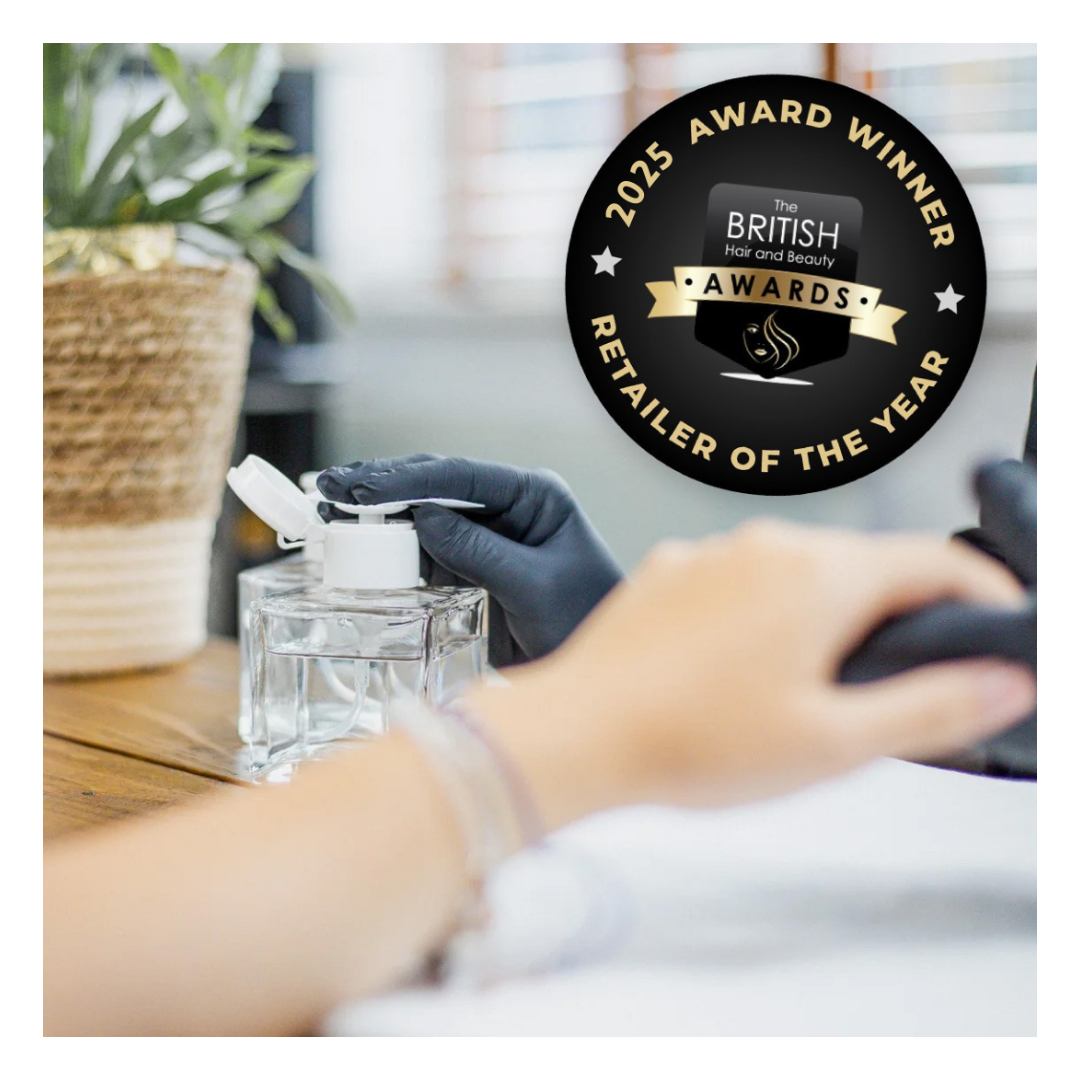 Professional nail tech applying acetone to a client at a professional luxury nail desk. 2025 Retailer of the Year' award badge overlay.